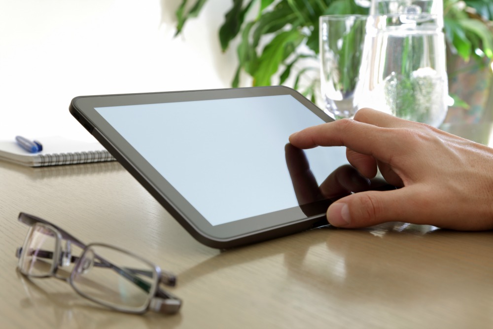 Businessman finger pointing to the screen of a tablet-pc